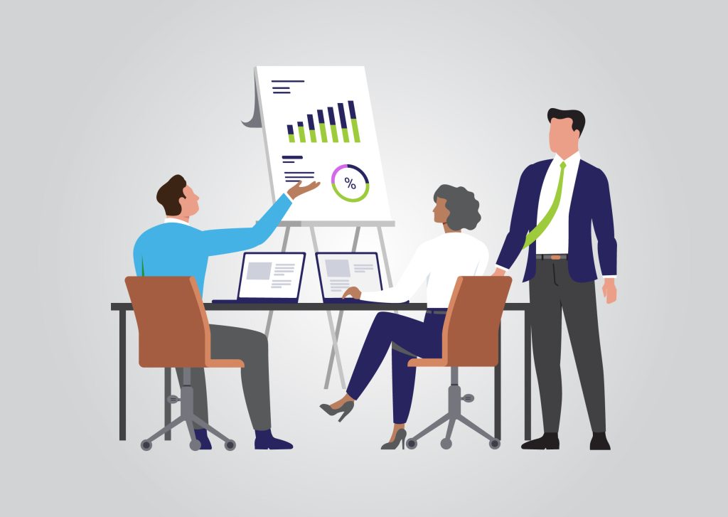 A leader stands and listens to two team members discussing information on the chart.